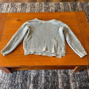 light blue ribbed sweater.